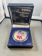 Painted 1999 US Silver Eagle coin in presentation box, .999 silver