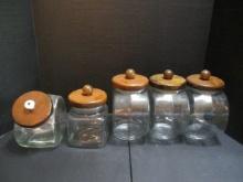 Five Glass Cannisters with Wooden Lids