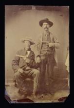 GOOD TINTYPE OF TWO COWBOYS HOLDING COLT SAA
