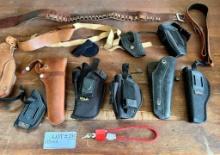 Assortment Of Gun Holsters And Ammunition Belt