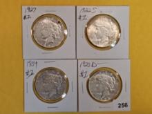 Four mixed Peace Silver Dollars