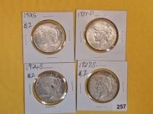 Four mixed Peace Silver Dollars