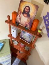 Jesus picture and two fake candles decor. Corner stand a picture of a fairy a little musical cat.
