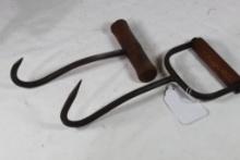 Two wood handled hay hooks