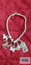 Silver colored charm bracelet marked 925 with silver colored charms some marked 925 total weight