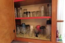 Two shelves of assorted glassware