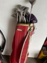 Red Golf bag and 10 assorted golf clubs