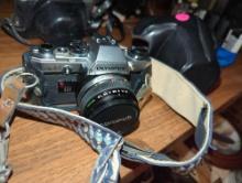 (LR) OLYMPUS OM10 CAMERA WITH PROTECTIVE CASE,