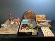 Vintage kitchen items, including cookie cutters, shakers measuring cups, and more