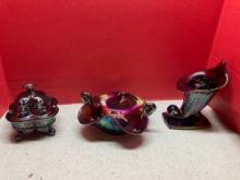 Three pieces of Fenton amethyst carnival glass, one with label