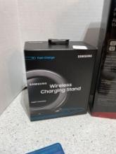 Samsung wireless charging stand, rocket fish, laptop, AC power adapter, my passport ultra auto and