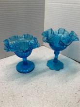 Two blue glass Fenton compotes
