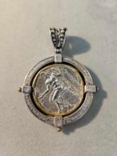 Silver pendant with ancient coin motif.